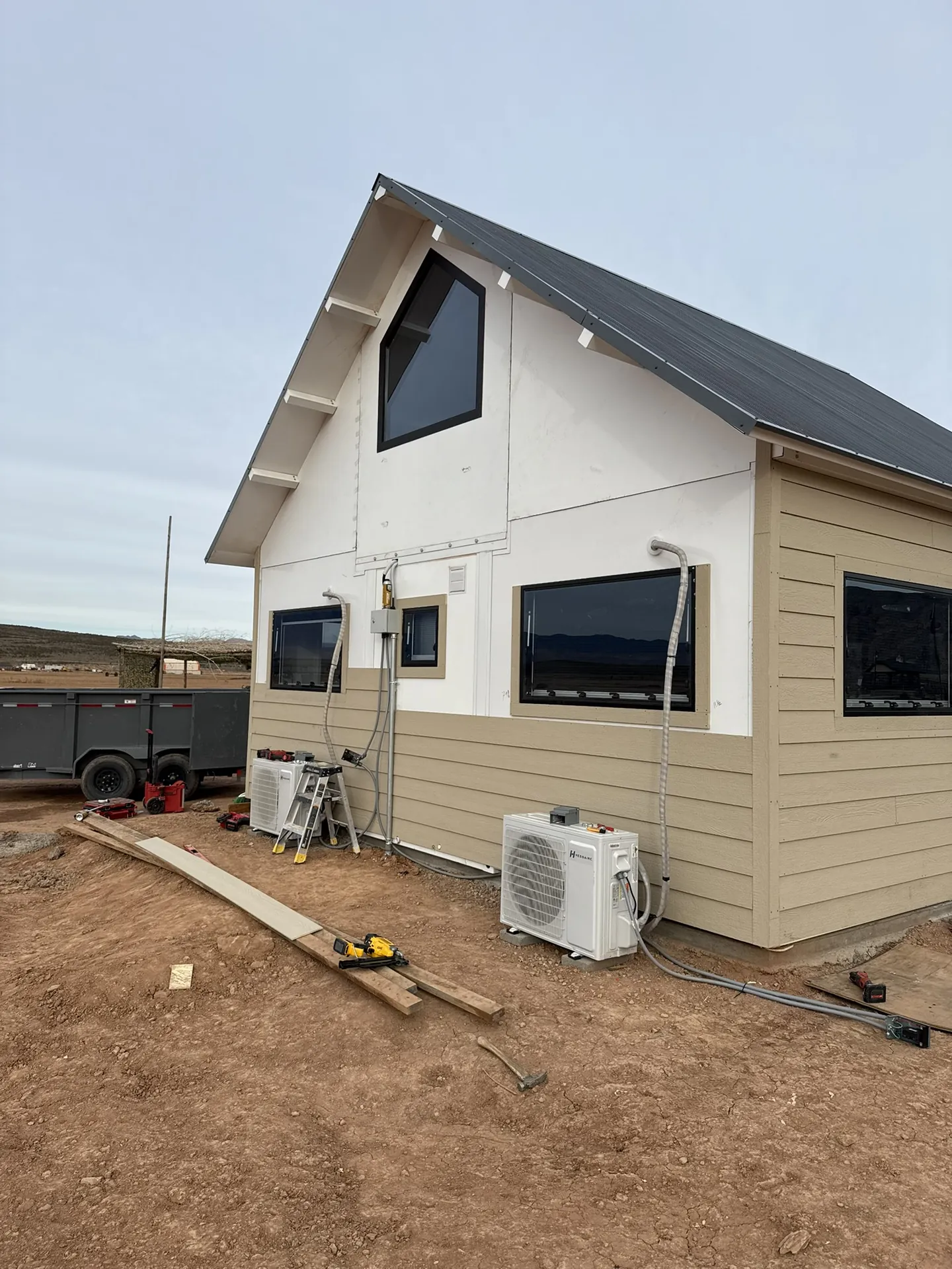Boxabl siding installation in progress — overcast conditions, tools on site, Hurricane Utah