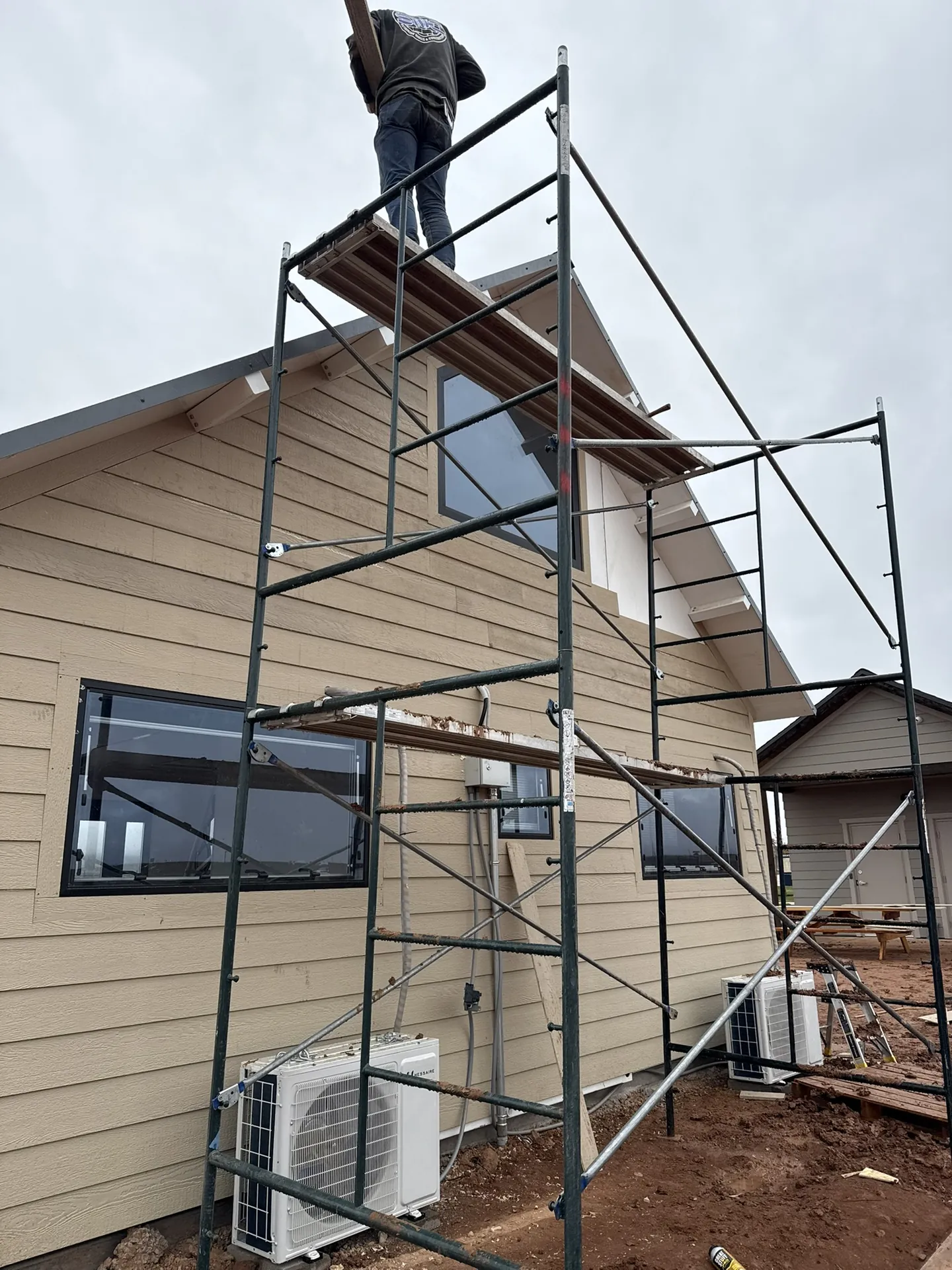 Viking Solutions crew on scaffolding during overcast conditions — Boxabl siding project Hurricane Utah