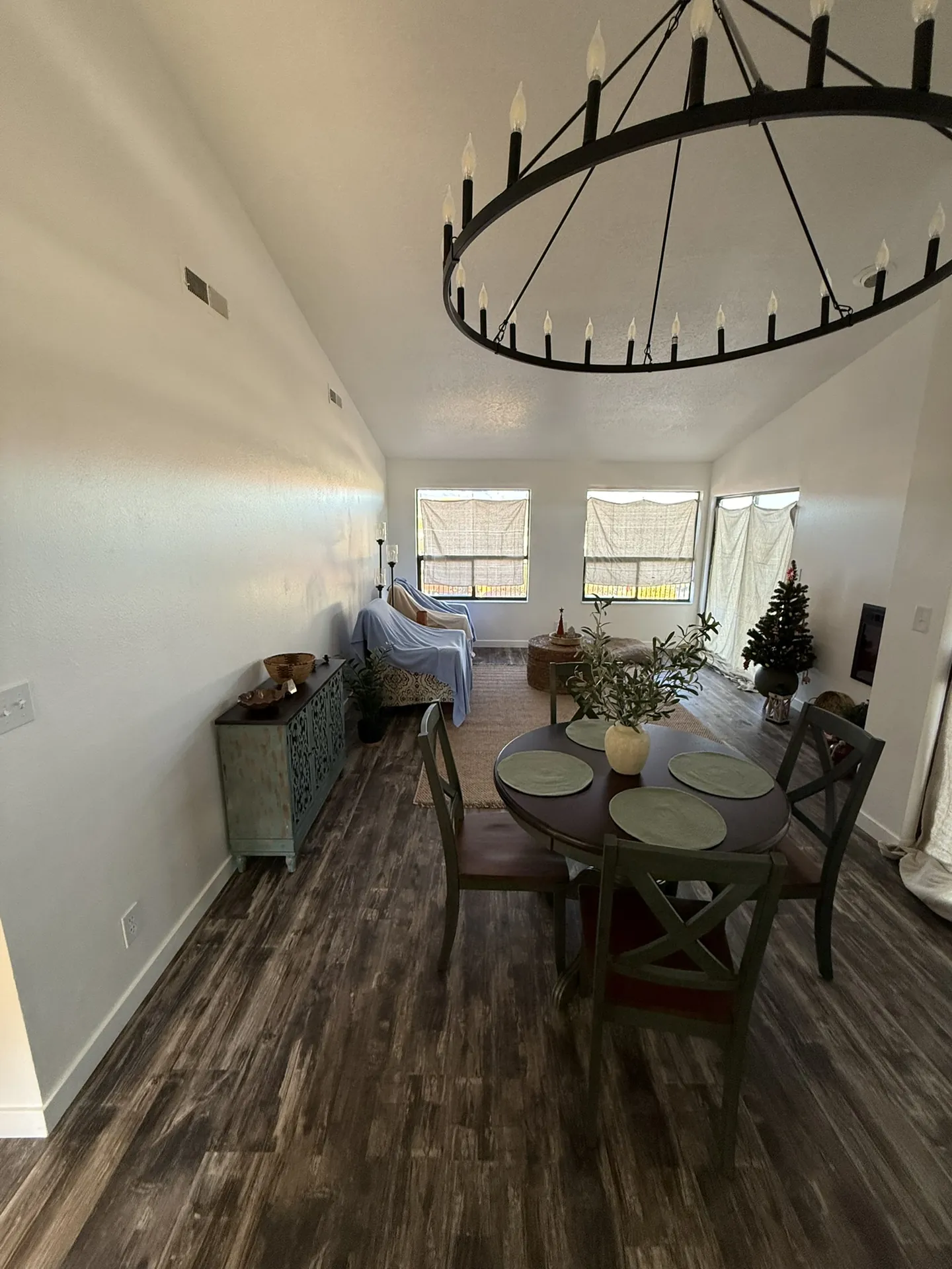 Finished living and dining area with new LVP floors, fresh paint, and new lighting