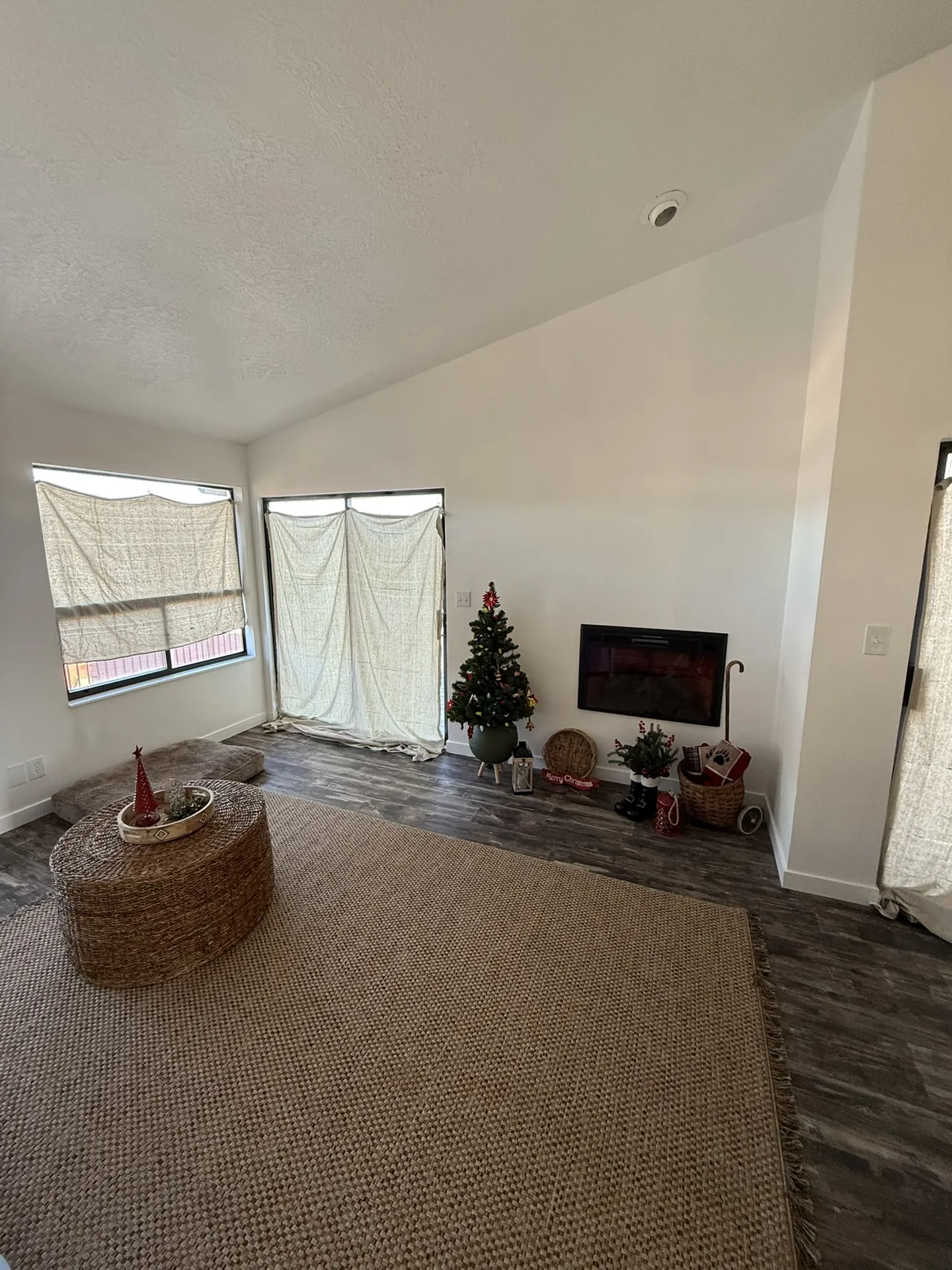 Finished condo living room with fireplace, new flooring, and updated finishes