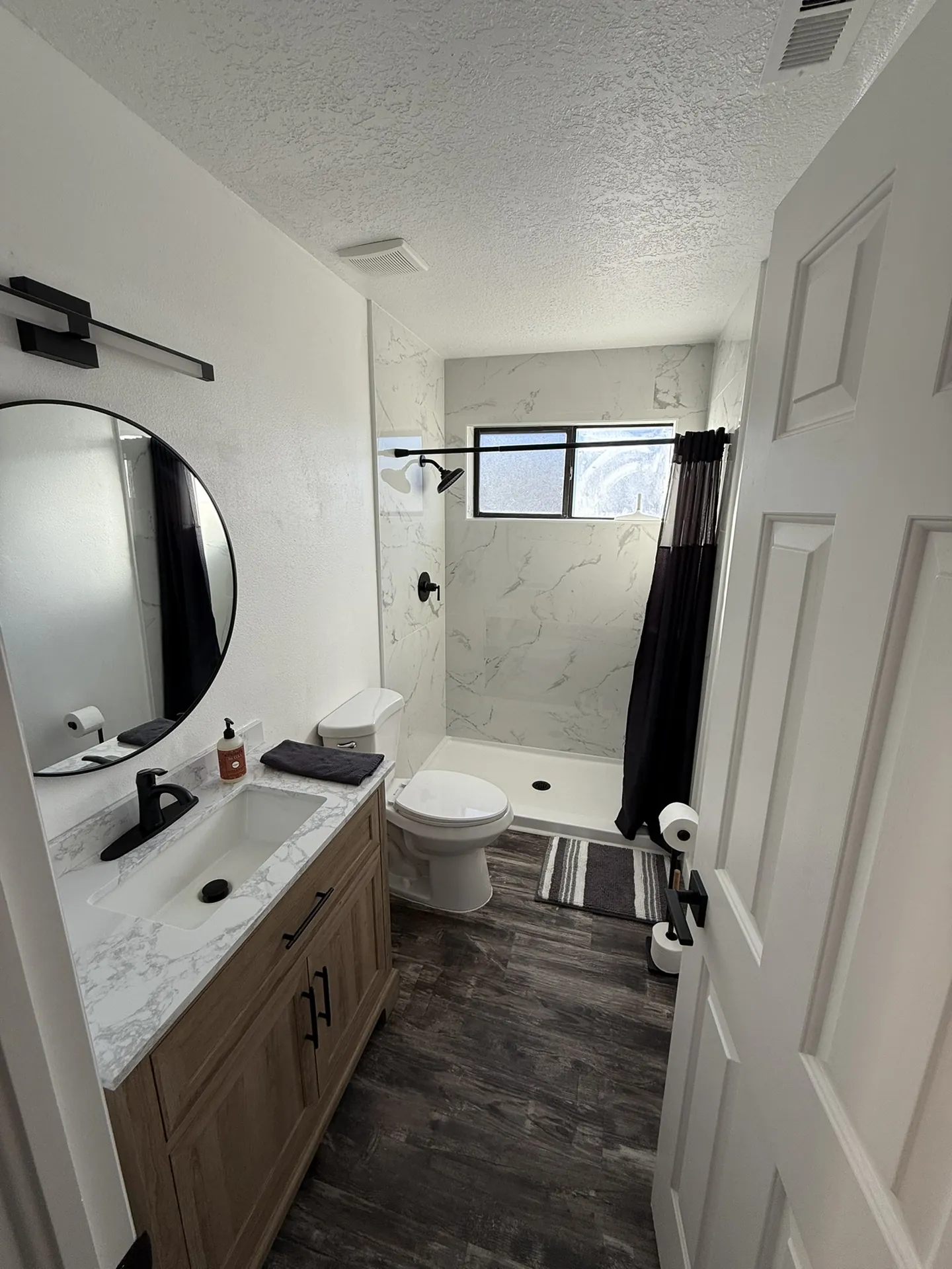 Remodeled master bathroom with new vanity, tile, and fixtures