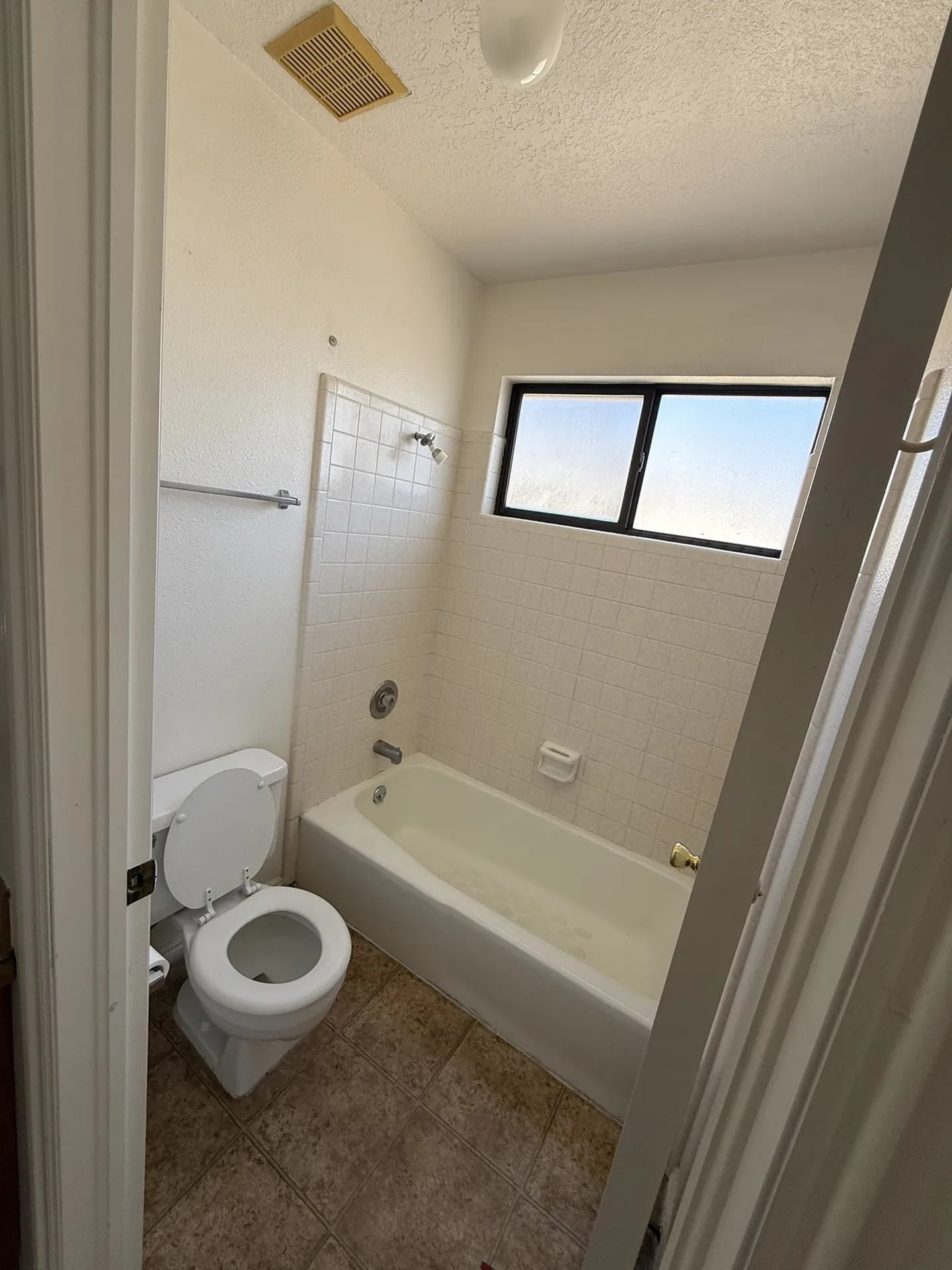 Hall bathroom before remodel with old tile and fixtures
