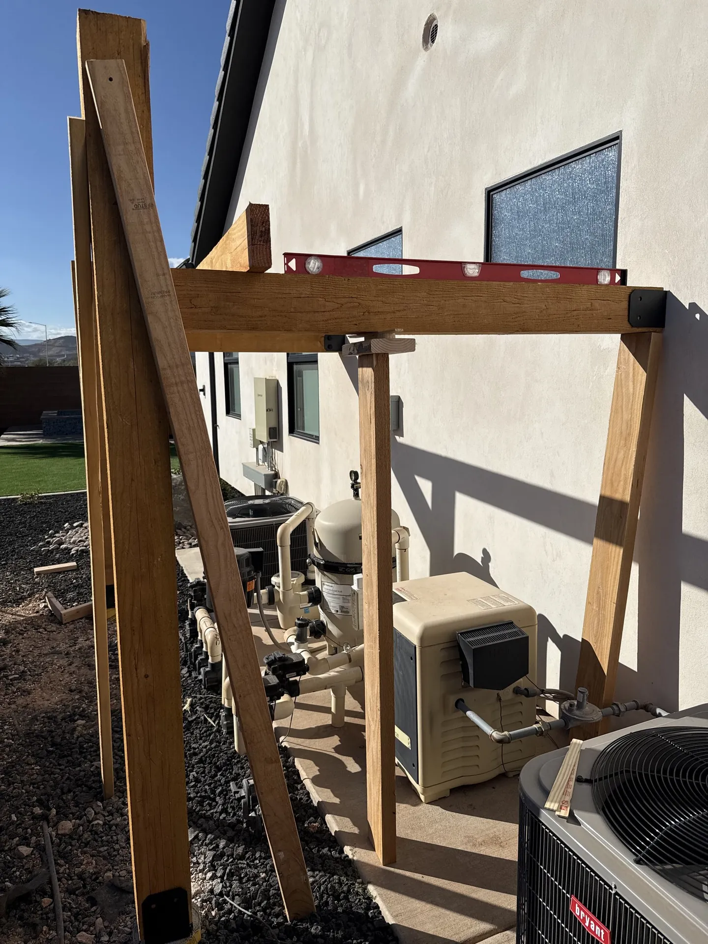 Finished pergola from an angle showing the pool equipment protected underneath