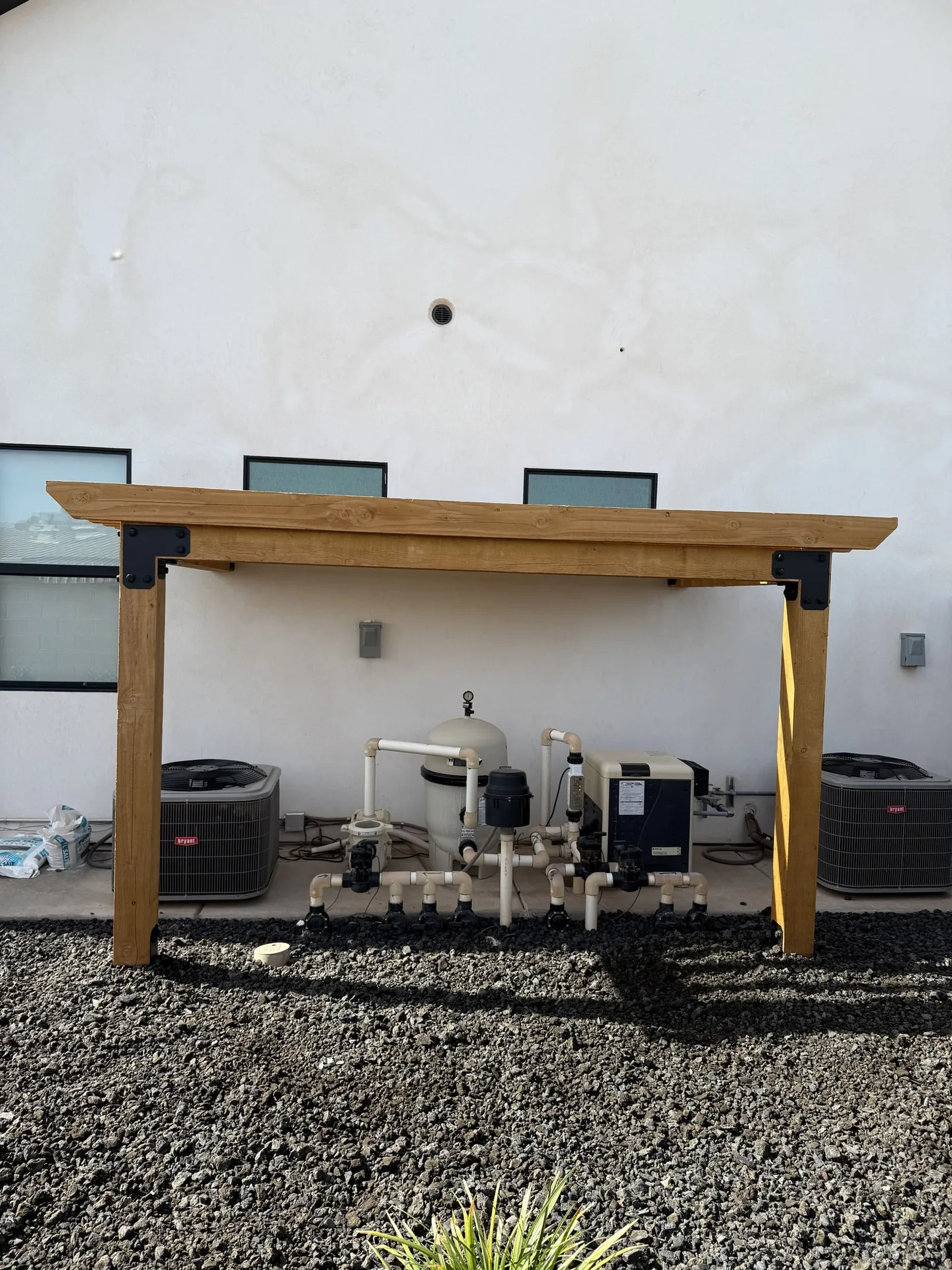 Front view of the cedar pergola showing clean beam and post framing with black steel hardware