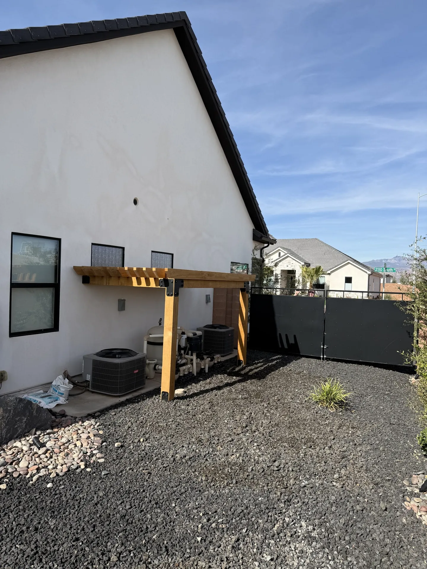 Side view of the home showing the pergola in context with the exterior