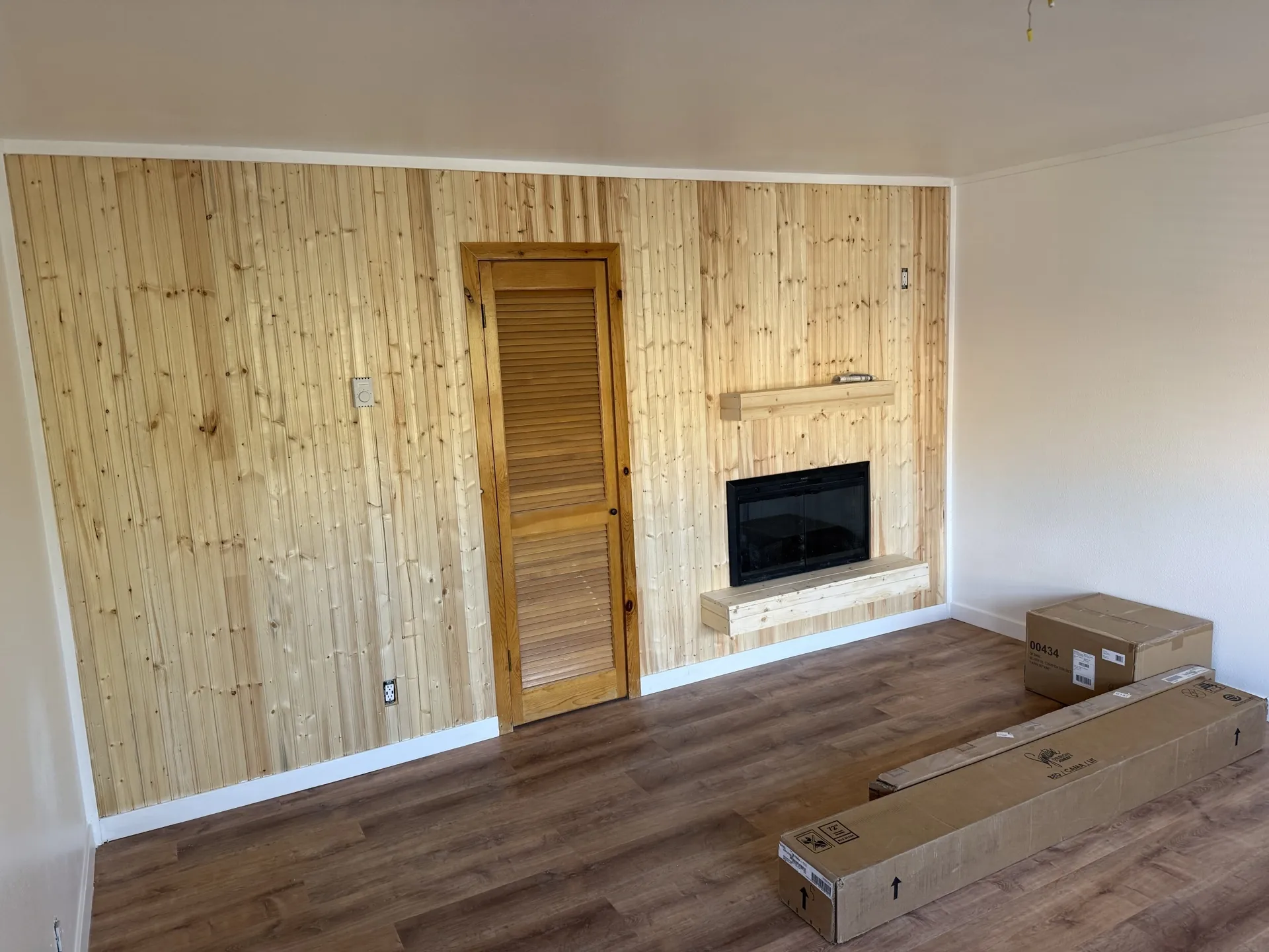 Brian Head studio before the remodel with worn flooring and dated finishes