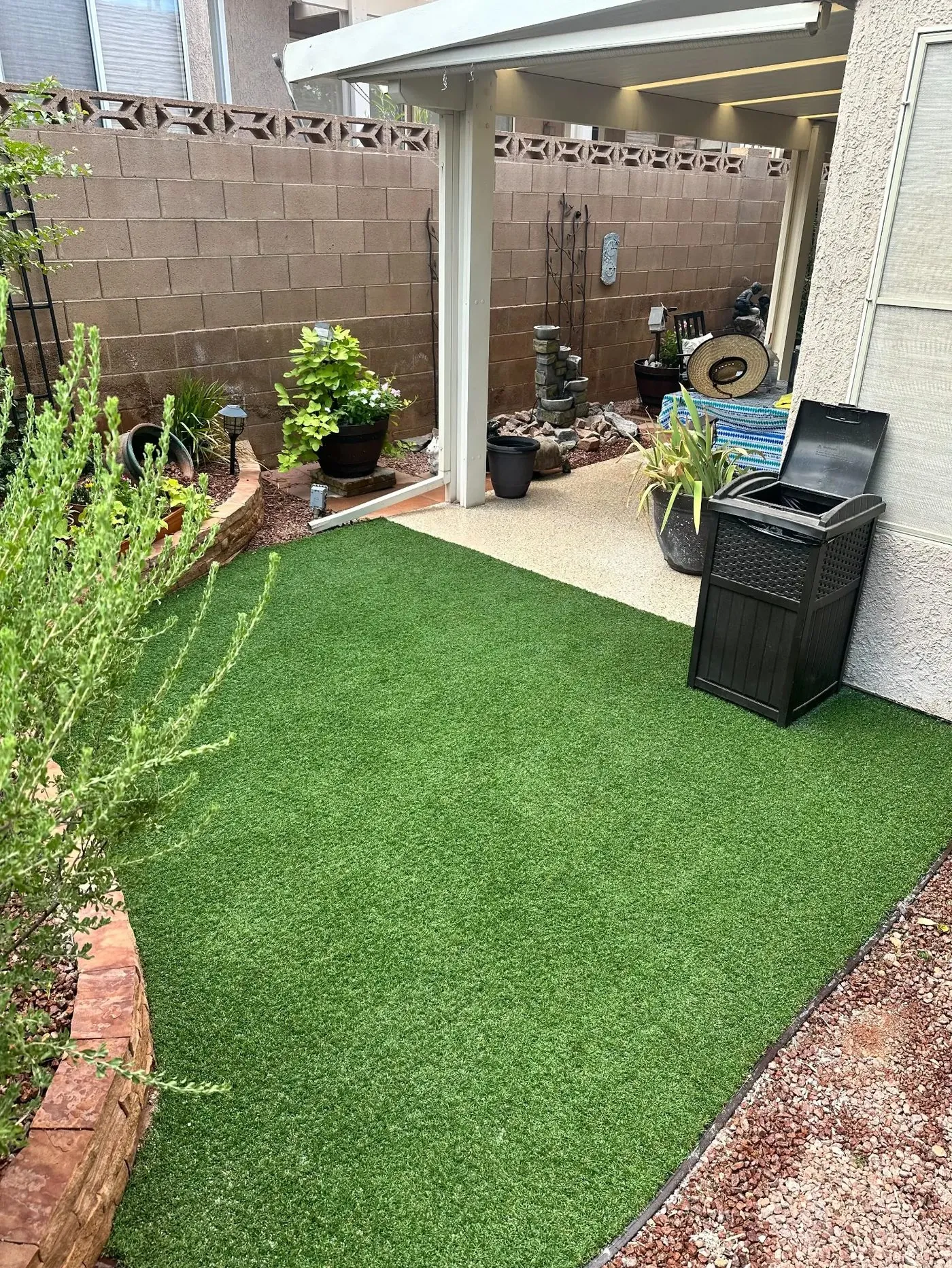 View from the covered patio across the finished green turf area