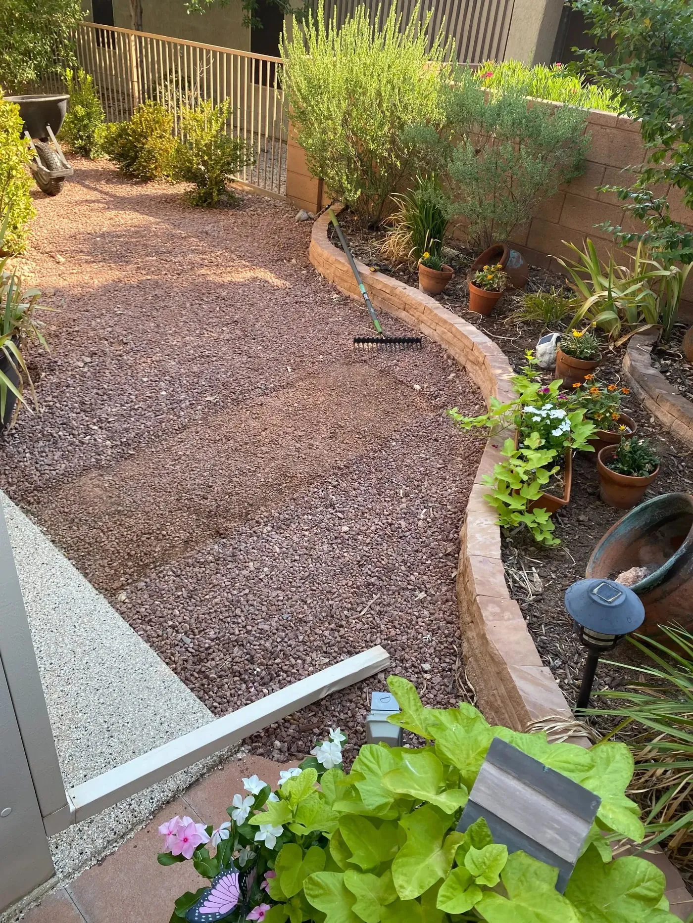 Gravel bed inside the curved retaining wall border before the turf install